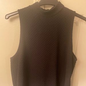 Black mock neck sleeveless top with button detail on back